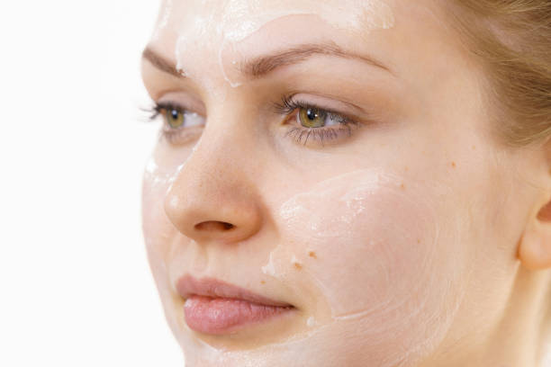 istock Girl with cream moisture cosmetic on face 1449407015
