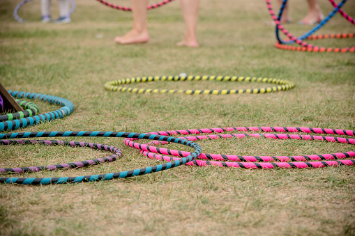Legs of people setting up some hulahoops for some fun and exercise