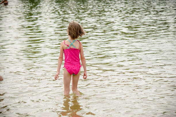 camminando nel lago - wading child water sport clothing foto e immagini stock