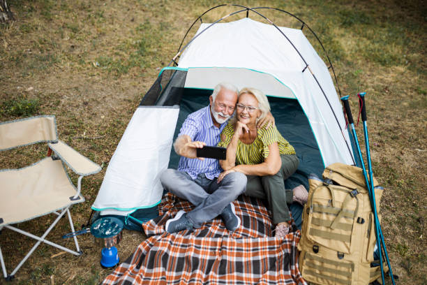 istock Senior Couple On Autumn Camping Trip having video call 1449410136