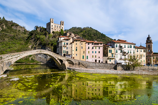 The medieval bridge on the river Nervia allows people to reach the old borough of Dolceacqua, dominated by the Castello Doria, a castle dating back to the 12th century.