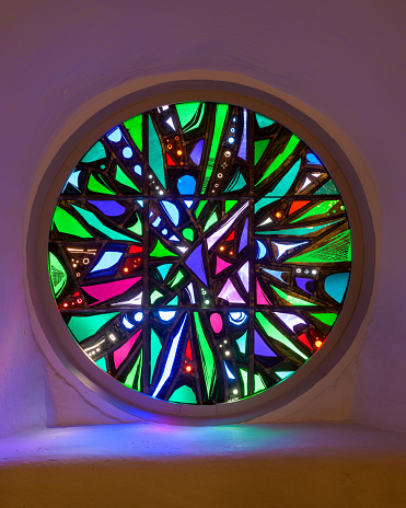 Laramie, Wyoming, USA - September 26, 2022: Round stained glass window inside the historic St. Matthew's Episcopal Cathedral in downtown Laramie