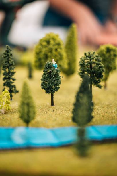 istock Vertical shot of a forest and a tree layout with a girl sitting on it 1449410493