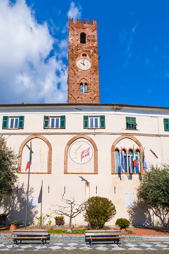 Town Hall of Noli with the high thirteenth-century clock tower and the recently made sundial with the municipal banner
