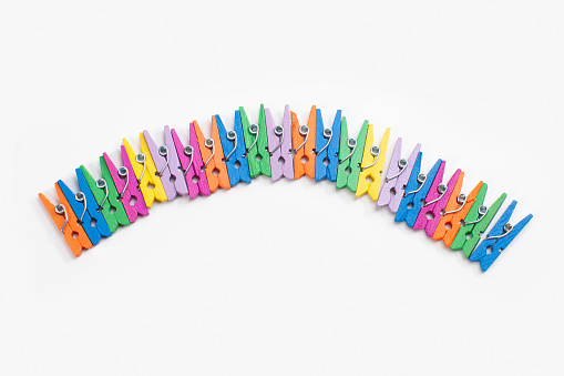 colorful clothes pegs isolated on white background