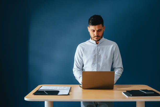 istock Serious Businessman Using Laptop Computer At Home 1449412204