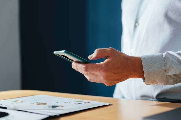 istock An Anonymous Businessman Using A Mobile Phone At Home 1449412275
