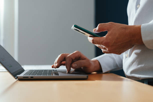 istock An Anonymous Businessman Using A Mobile Phone At Home 1449412310