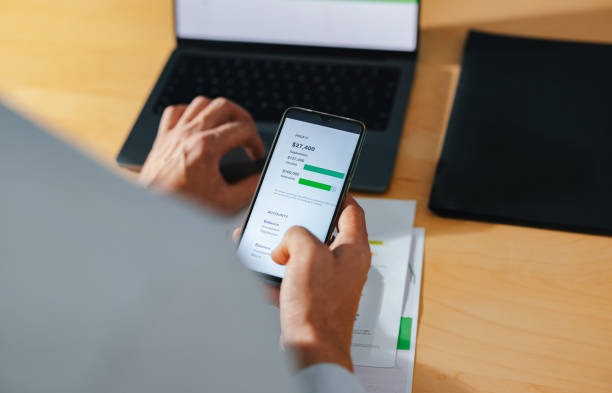 istock High Angle View Of Unrecognizable Businessman Using A Mobile Phone At Home 1449412384