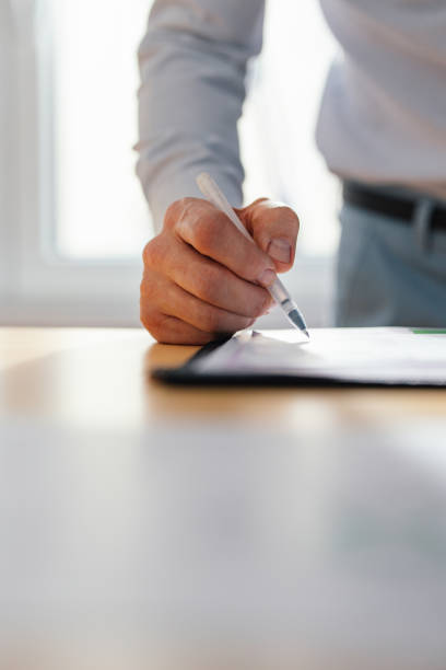 istock An Anonymous Businessman Working With Documents At Home 1449412400