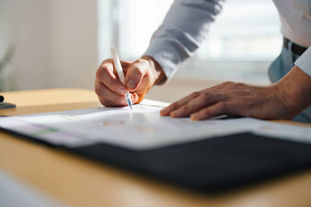 Unrecognizable Businessman Working With Documents At Home