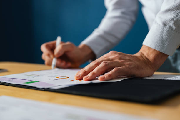 istock Unrecognizable Businessman Working With Documents At Home 1449412436
