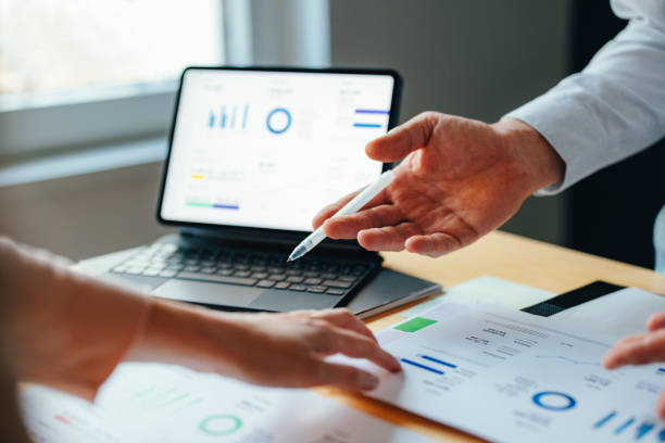 istock Anonymous Businesspeople Analyzing Business Graphs and Documents Together 1449412463