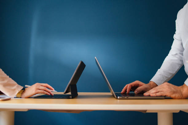 istock Unrecognizable Businesspeople Working On A Digital Tablet And Laptop Computer 1449413036