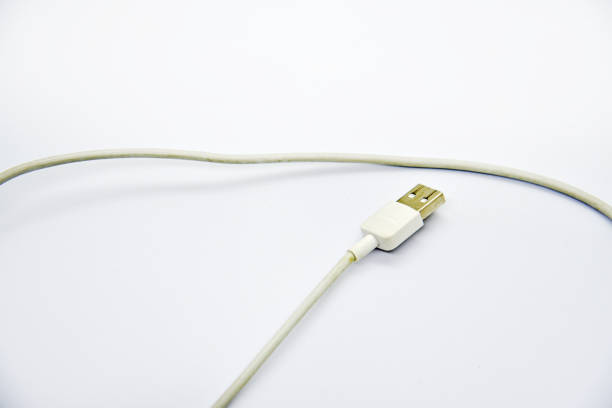 istock White USB cable for charging the phone on a white background. White cord for charging gadgets. 1449414735