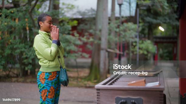 Female Tourist Visiting Shrine And Praying Stock Photo - Download Image Now - 20-24 Years, Active Lifestyle, Adult