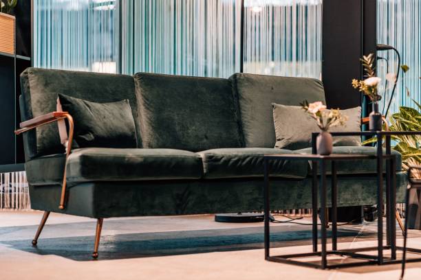 istock Closeup of a comfortable black sofa in an empty living room 1449418657