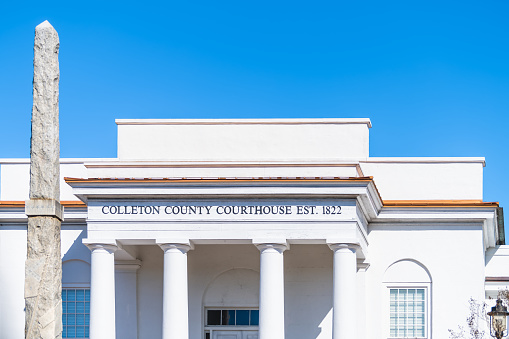 Walterboro, USA Colleton county courthouse clerk of court building sign at white architecture facade in South Carolina city