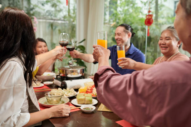 istock Family Toasting at Dinner Table 1449418840