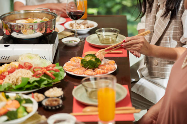 istock Guest Taking Shrimp from Plate 1449418885