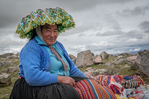 iqu, Peru – November 02, 2021: A local woman selling goods outdoors in Peru