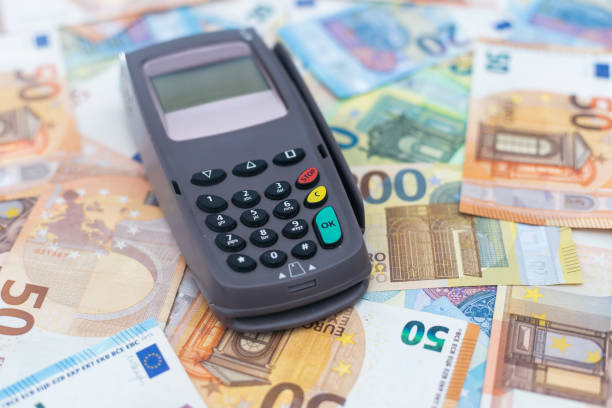 istock Banking terminal on euro banknotes background close up 1449425129