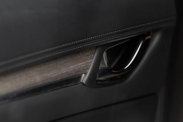 istock Modern car interior door handle close up. Metallic Car door opener handle inside. 1449425391