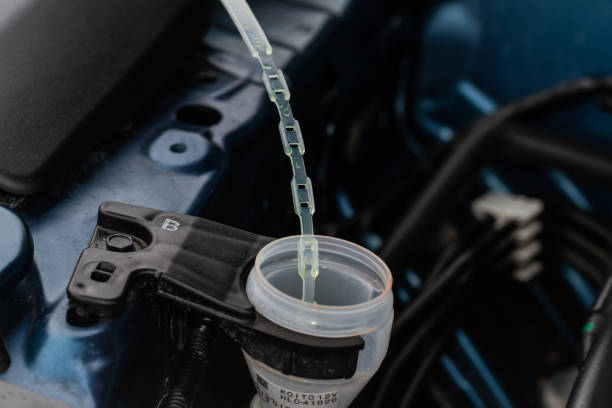 istock Closeup blue windshield washer fluid reservoir cap. Car engine windshield washer fluid reservoir cap close-up 1449425467