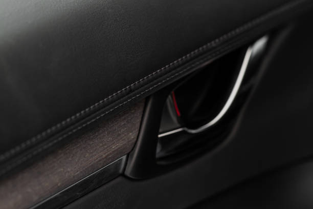 istock Modern car interior door handle close up. Metallic Car door opener handle inside. 1449426202