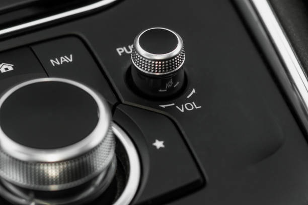 istock Volume control of car audio system. FM radio button in car panel. 1449426310