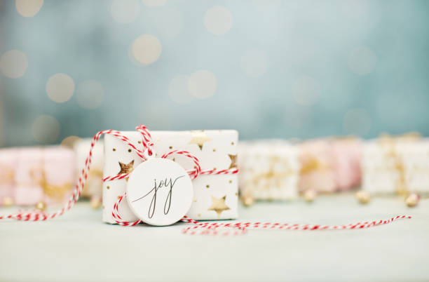 istock Christmas gift background with gift tag reading JOY 1449426463
