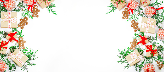 Christmas holiday banner with gift boxes, gingerbreads, fir tree branches and xmas balls isolated on white background