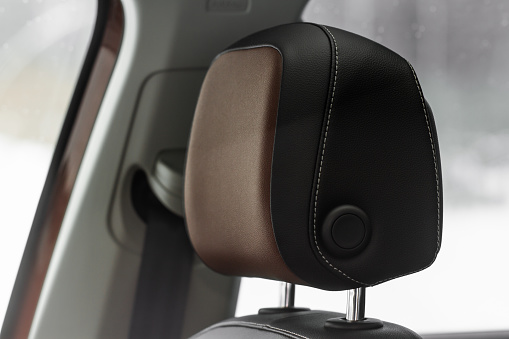 Leather headrest in car interior.