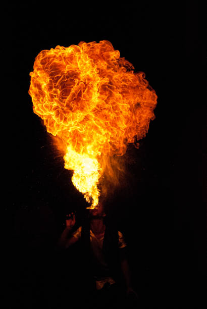 istock flames spit by a juggler in the dark 1449428439