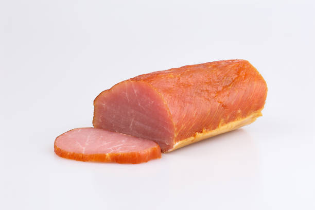 Raw smoked salmon with a cut piece on a white background