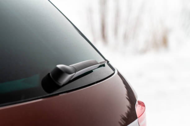 istock Winter back car window. A car wiper cleans the rear window. 1449429900