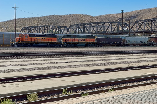 Barstow California USA, October 26, 2019. Burlington Northern and Santa Fe (BNSF) freight train operates in the Barstow California railroad station. A busy rail yard with both passenger and freight trains using the multiple tracks and switching facility.