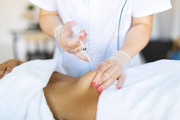 istock Cosmetologist making injections for body correction 1449431978