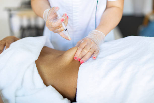 istock Cosmetologist making injections for body correction 1449432049