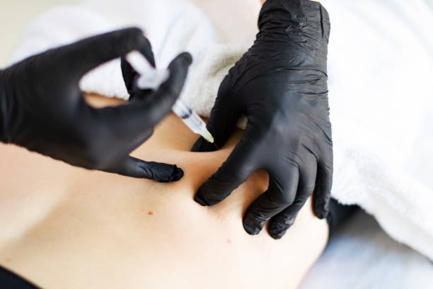 istock Cosmetologist making injections for body correction 1449432100