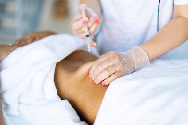 istock Cosmetologist making injections for body correction 1449432184