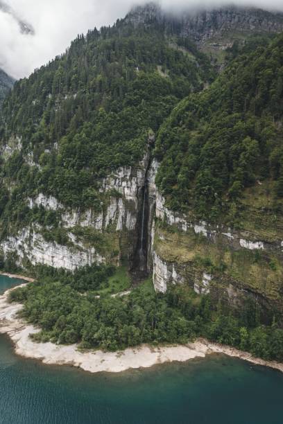 istock Drone vertical shot of a river and mountain with waterfall and greenery 1449432259