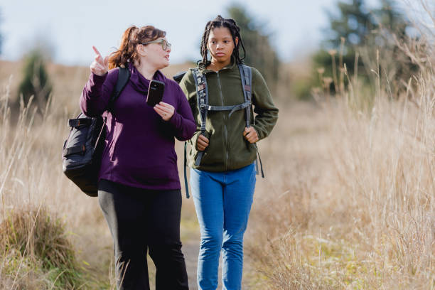 istock Multi Racial Mom and Daughter Winter Hike Together 1449433011