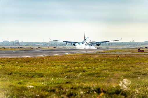 Airplane on airport, ready to take off. A set of luggages are on the ground beside the aircraft