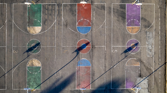 High quality stock photo looking directly down at multi-colored basketball courts.