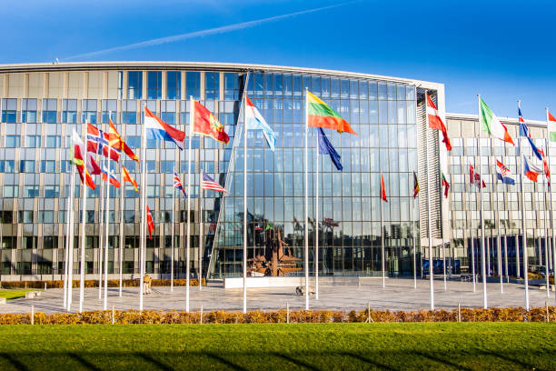 NATO building headquarters with flags and symbol outside stock photo
