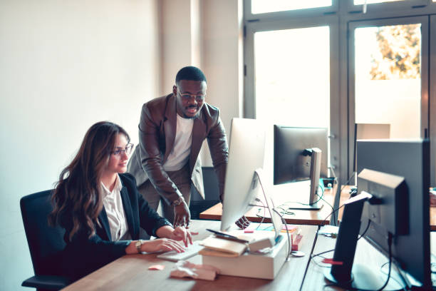 istock African Male Helping Female Intern With Programming 1449438447