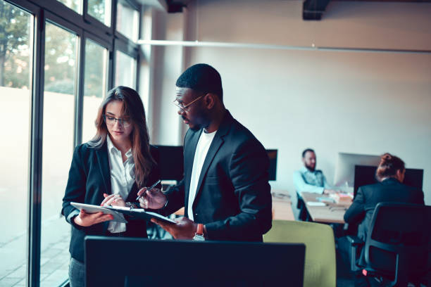 istock Female Financial Expert Helping African CEO Navigate Through Multitude Of Documents 1449439209