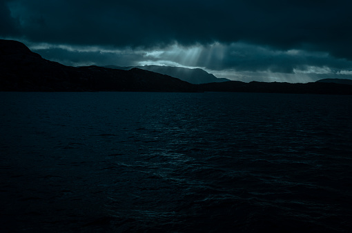 View at sea from passenger cruise ferry boat, during a dark moody winter day