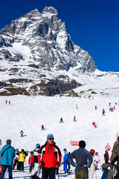 Cervinia, Italy, February 14, 2007: the ski season on the Italian Alps, April 7, 2022 in Cervinia, Italy. People skiing on the with slopes during a nice winter day